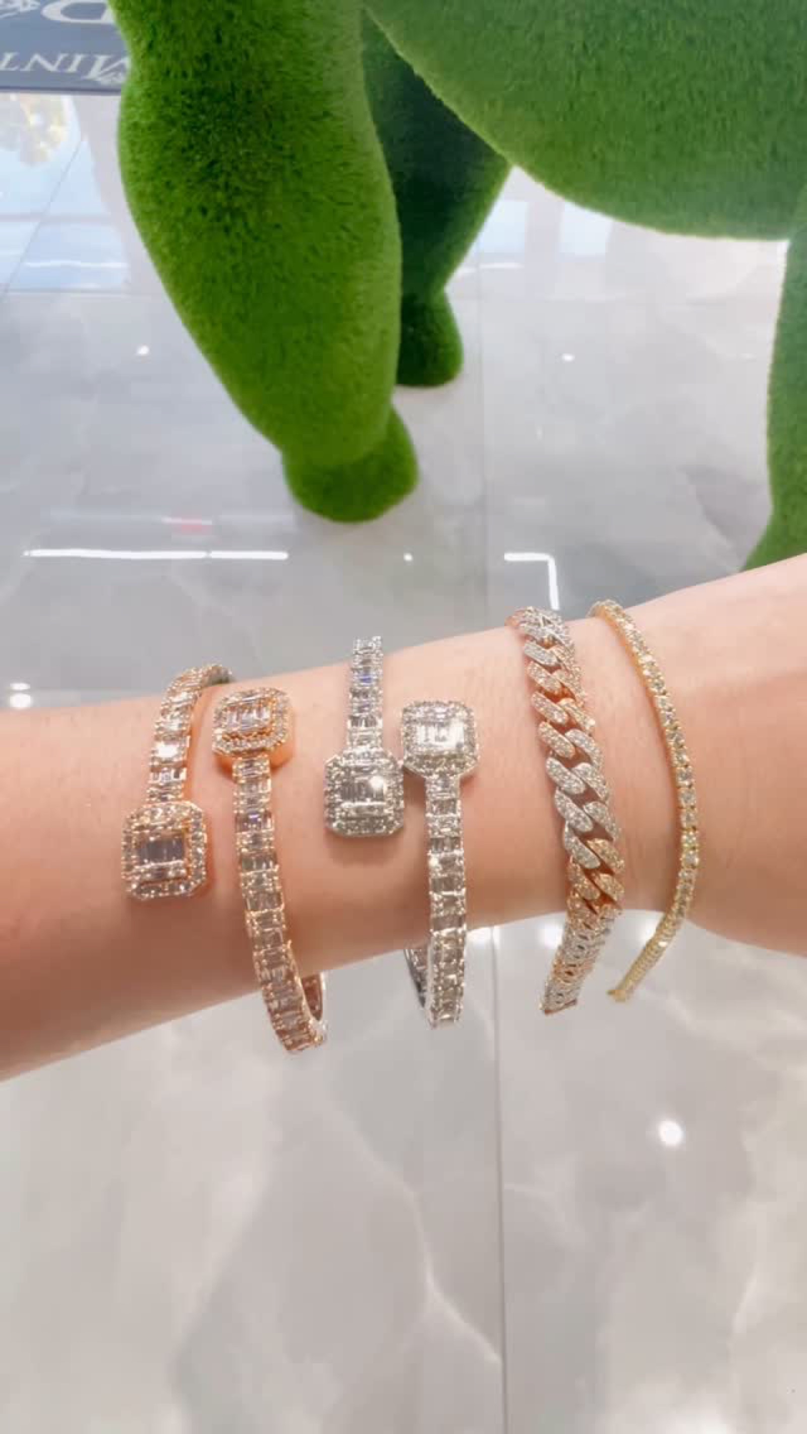 Diamond tennis and Cuban bracelets stacked on a wrist