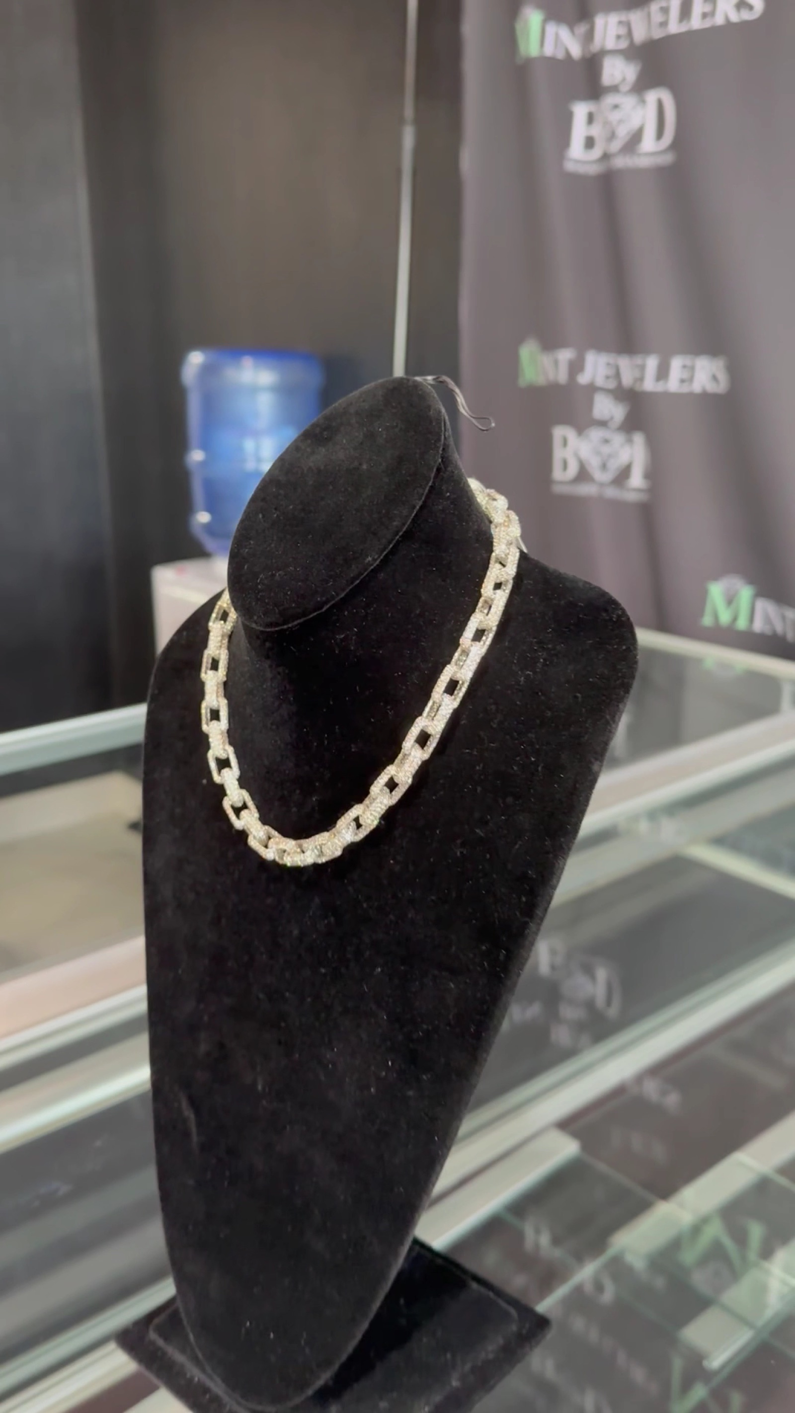 A diamond tennis necklace on a bust at the Mint Jewelers counter